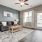 a living room with a rug and a fan