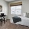 a bedroom with a bed and a desk