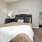 a bedroom with a bed and a mirror