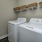 a laundry room with a laundry basket on the wall
