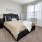 a bedroom with a bed and a chair